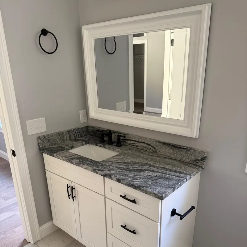 Stone vanity top with white cabinet