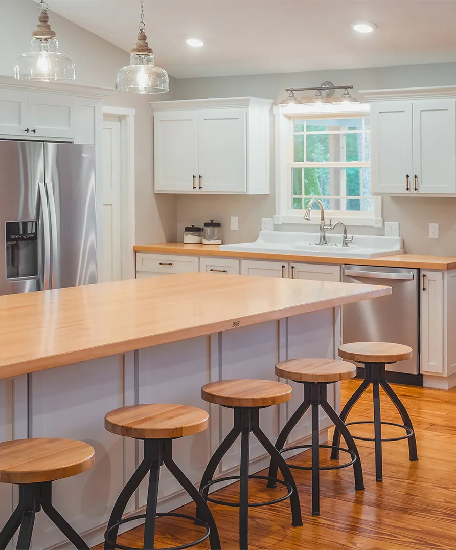 A John Boos maple butcher block island top in a bright kitchen