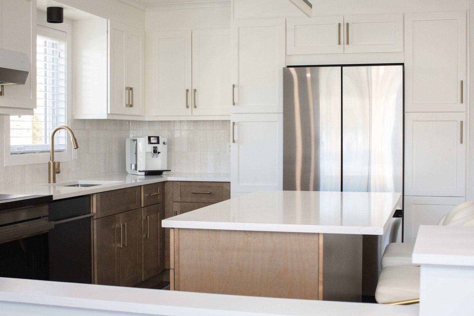 A kitchen with a long run of base and wall cabinets