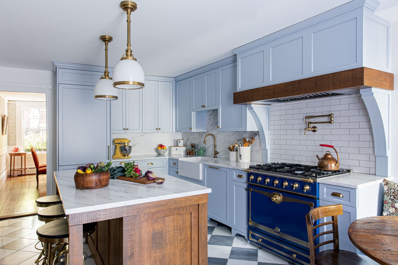 A periwinkle-blue custom kitchen with a wood island
