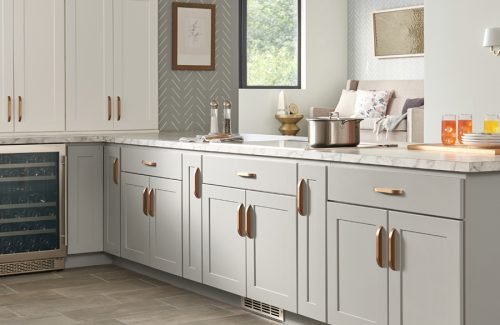 Grey shaker kitchen with copper cup pulls