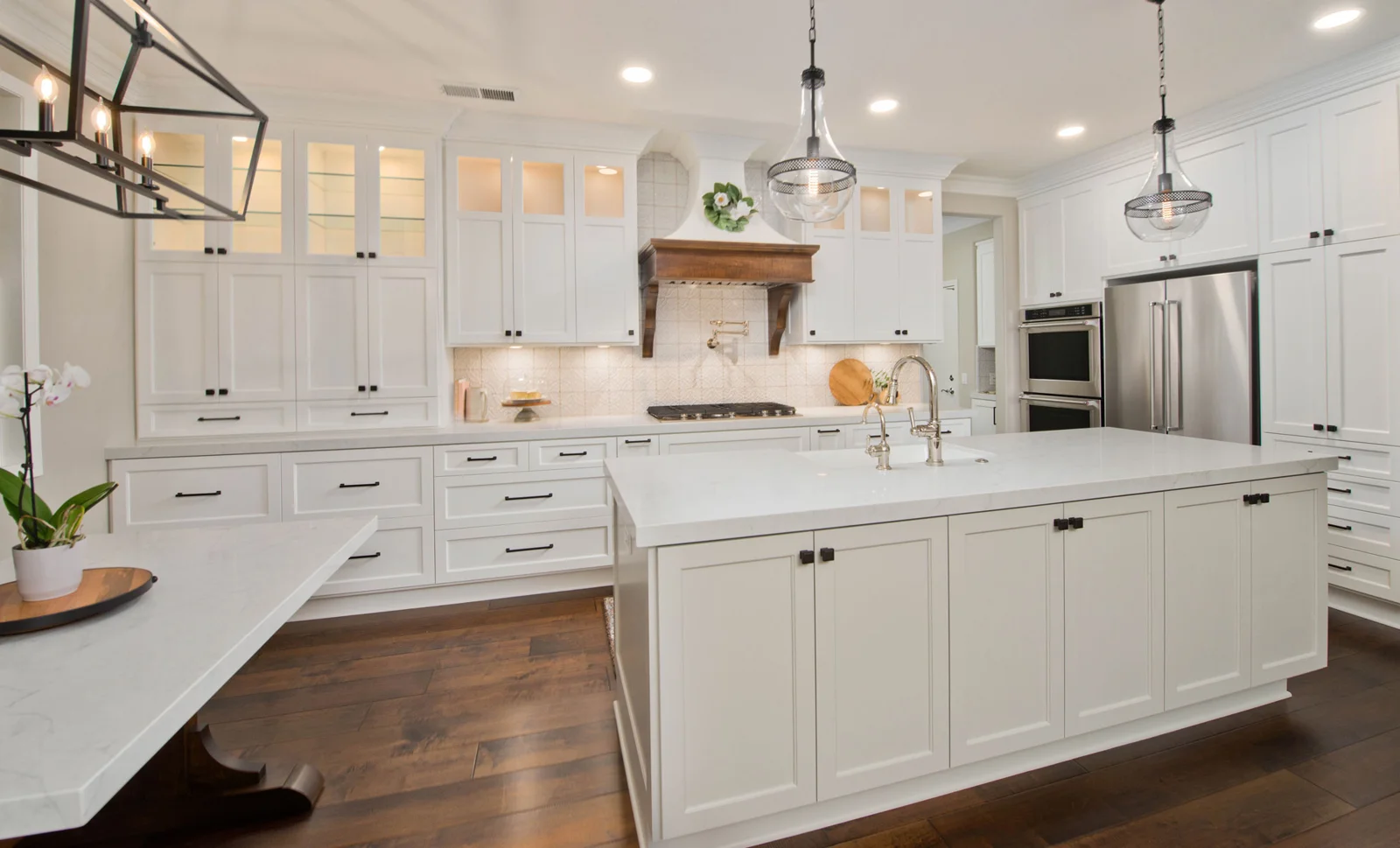 Finished New Hampshire kitchen with a stone island and full-height backsplash