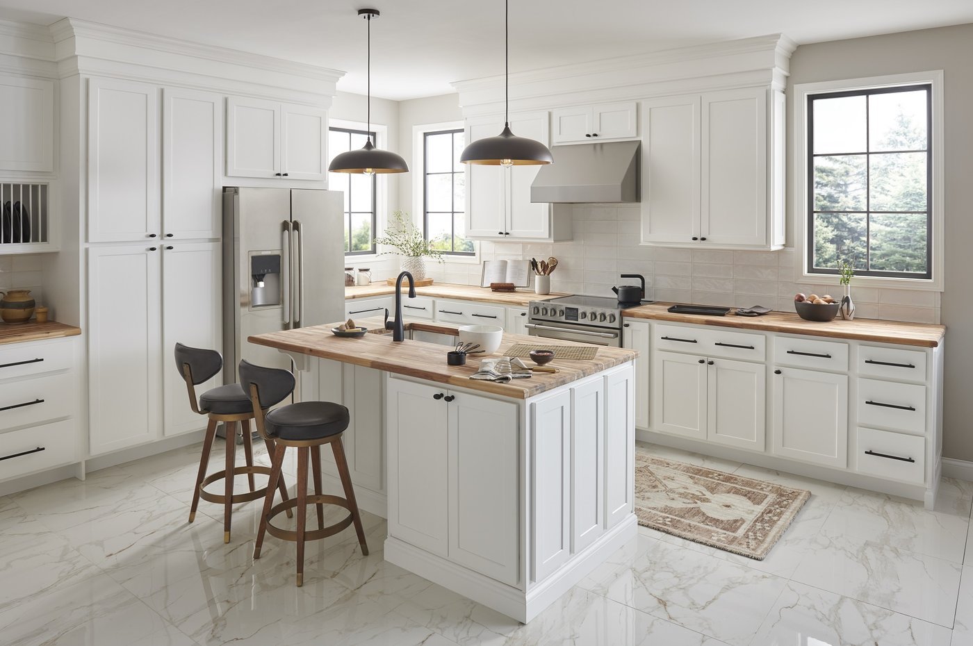 Greige shaker kitchen with wood counters and black pendants