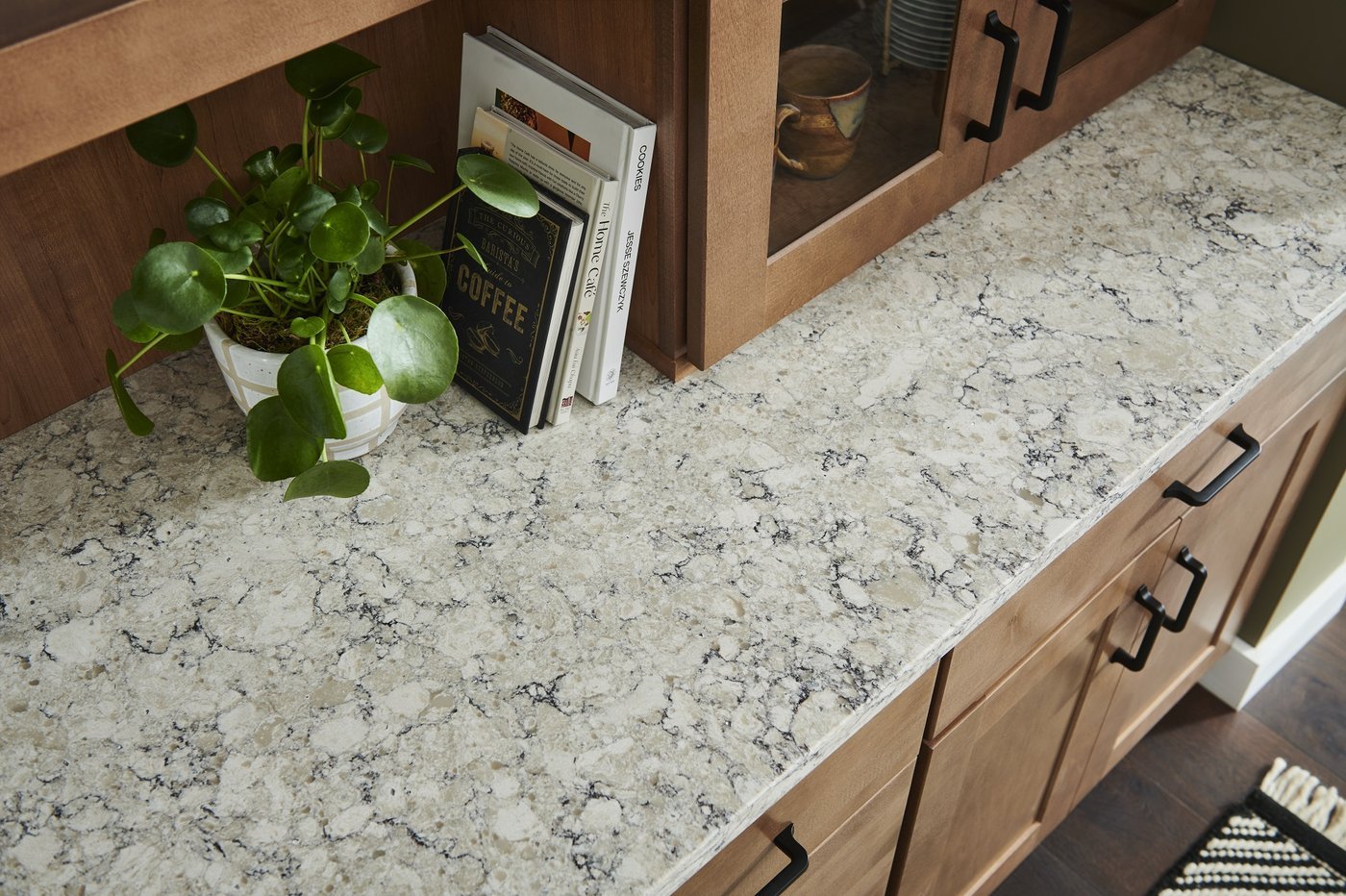 Warm wood kitchen with a veined white stone counter