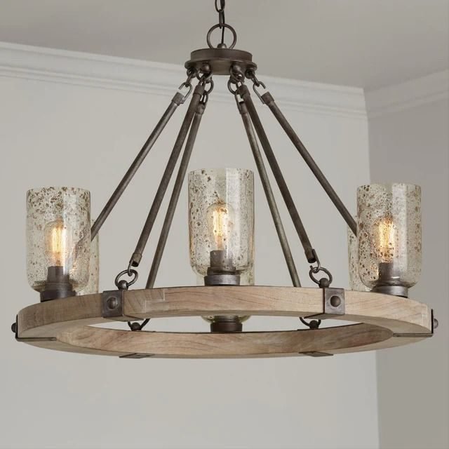 A rustic wood wagon-wheel chandelier with seeded glass shades