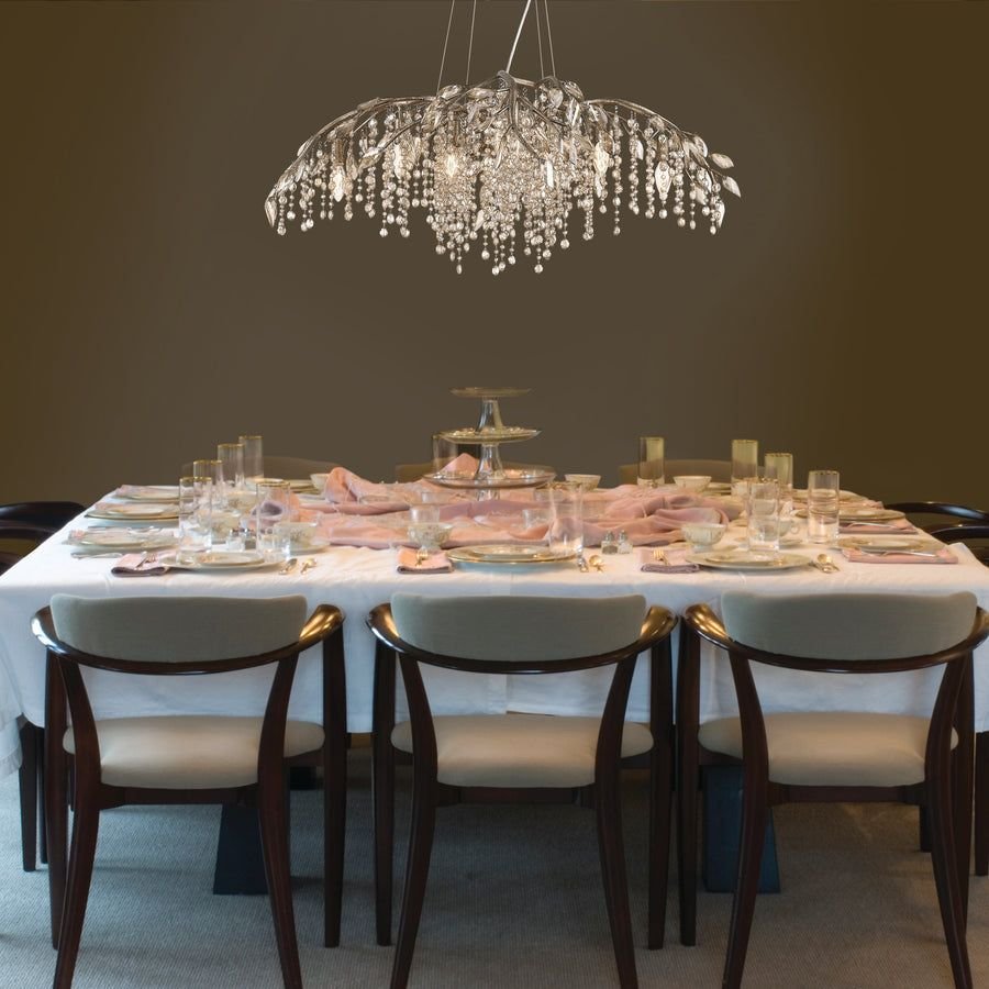 Crystal chandelier above a blush and white dining table