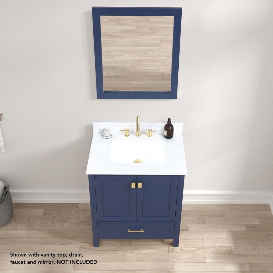 Navy blue bathroom vanity with white top and brass accents