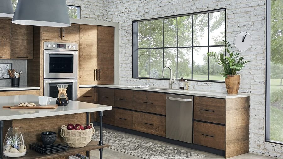 Warm wood kitchen with pale counters and black-framed windows