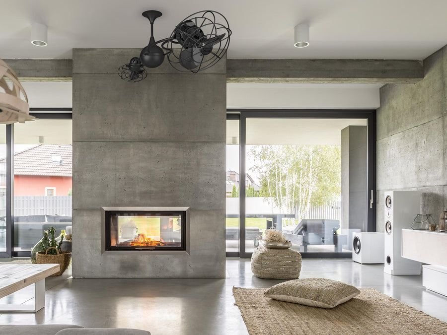 Concrete fireplace living room with a black dual-head fan