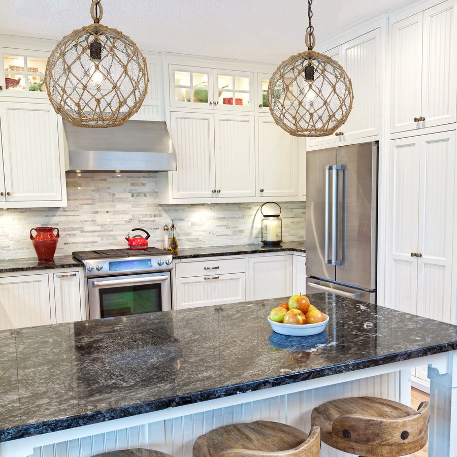 White shaker kitchen with chestnut orb pendants and granite island