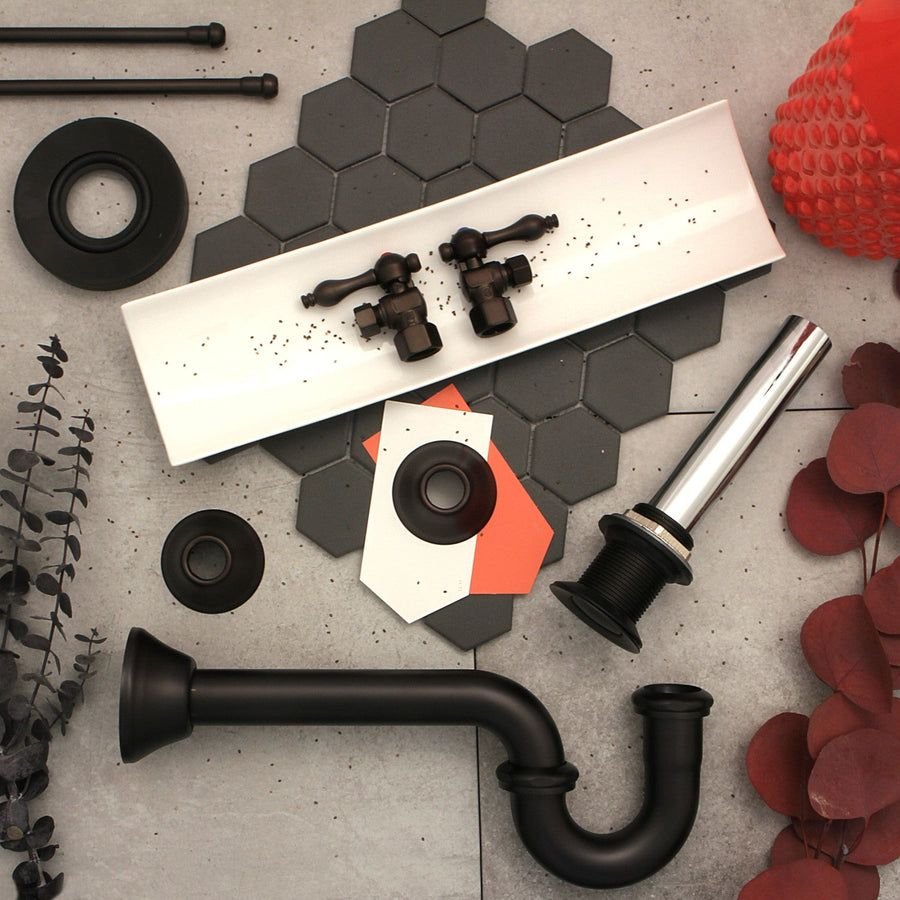 Bathroom fixtures in bronze and chrome on charcoal hex tile