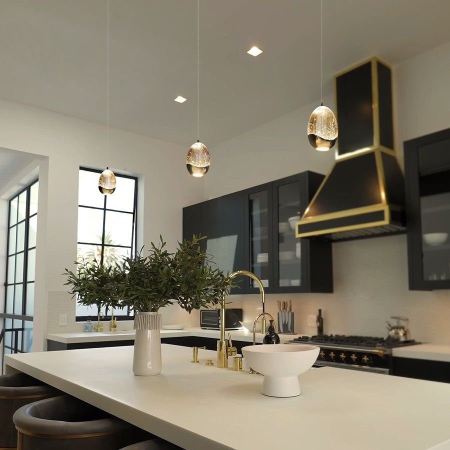 Warm kitchen with black cabinets and brass accents