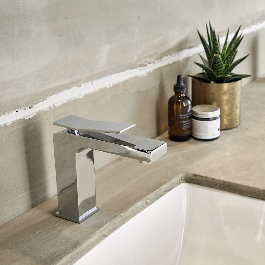 Gerber Avian chrome faucet on a warm beige stone vanity