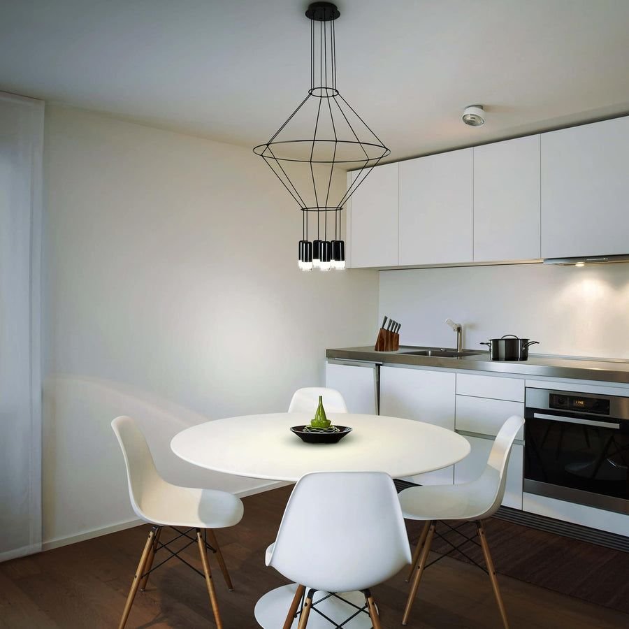 Minimal white kitchen with a black geometric pendant light