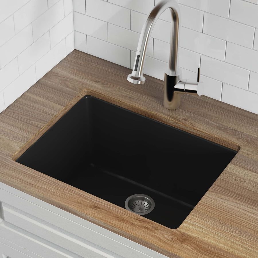 Black undermount sink with wood counter and steel faucet