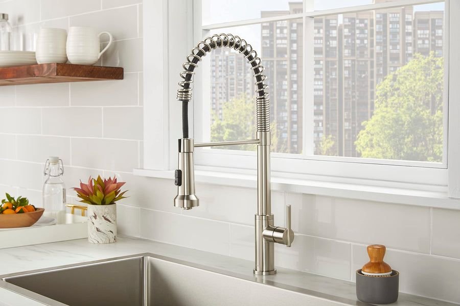 Bright white kitchen with gray tile and a spring pull-down faucet