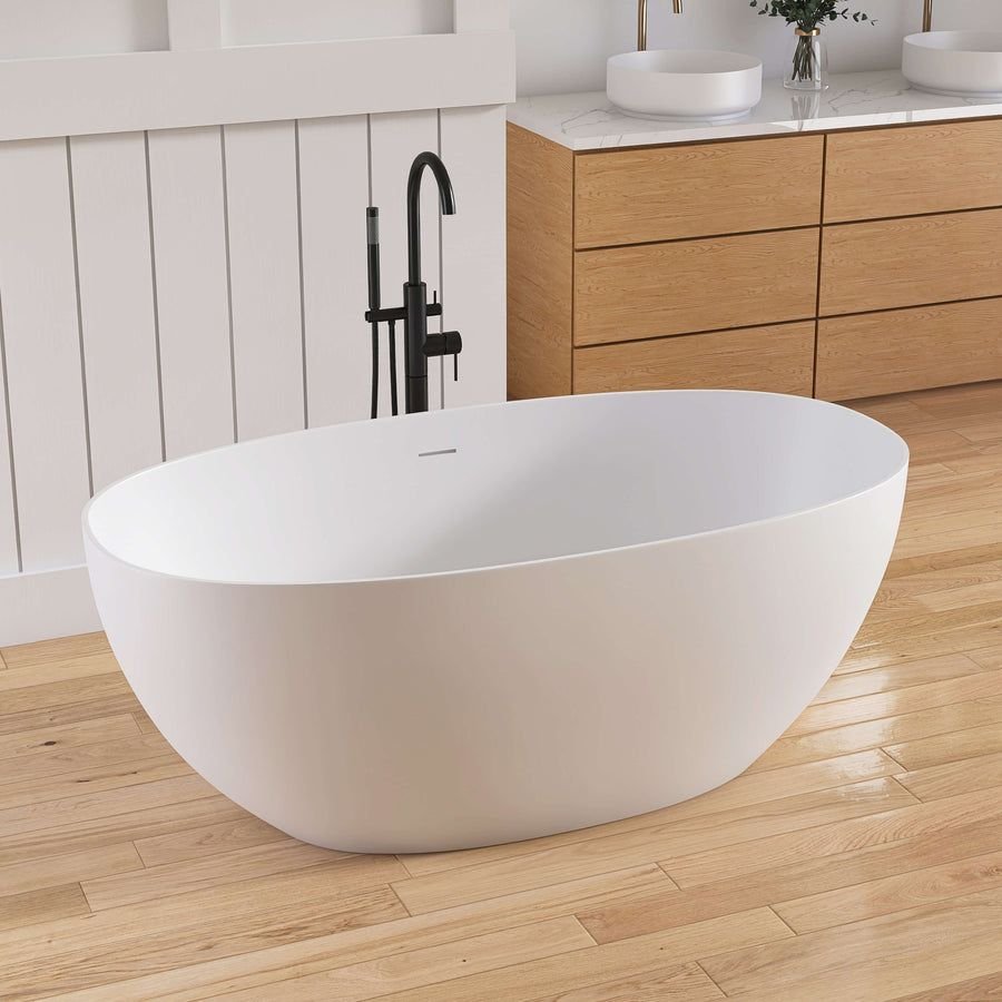 White freestanding tub with black faucet and warm wood