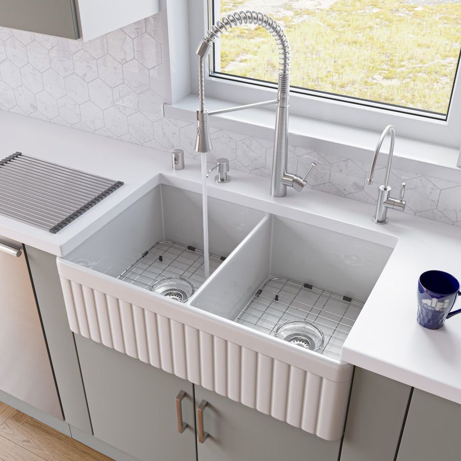 White fluted farmhouse sink with double bowls and chrome faucet
