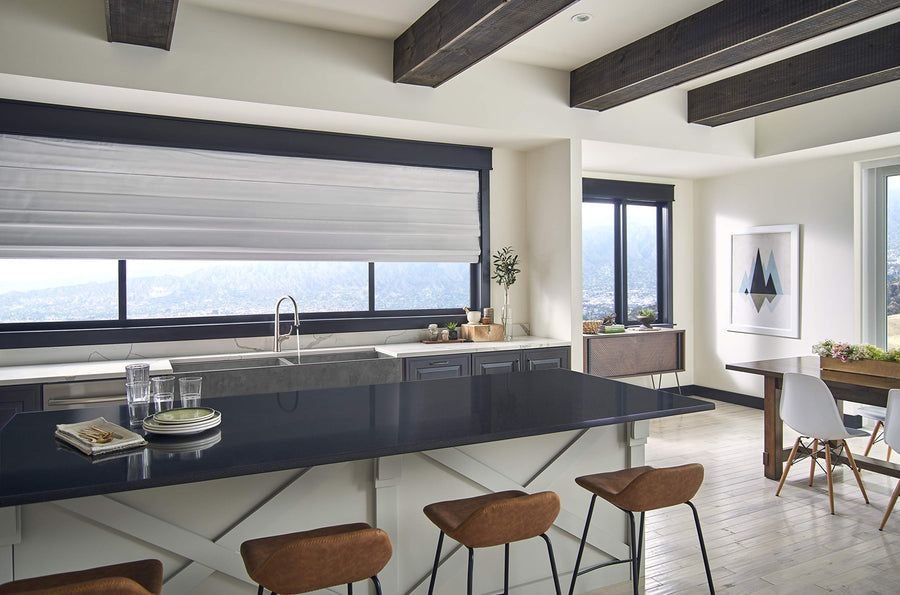 Gray kitchen with a Gerber pull-down faucet and dark island