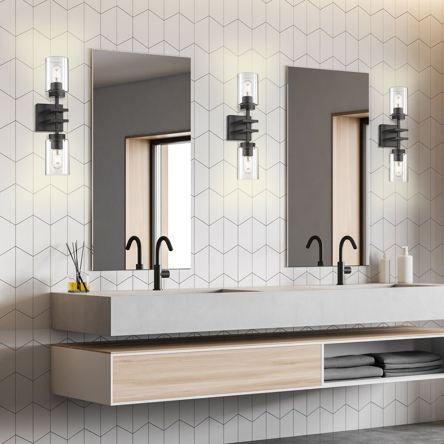 Gray double vanity with geometric tile and black sconces