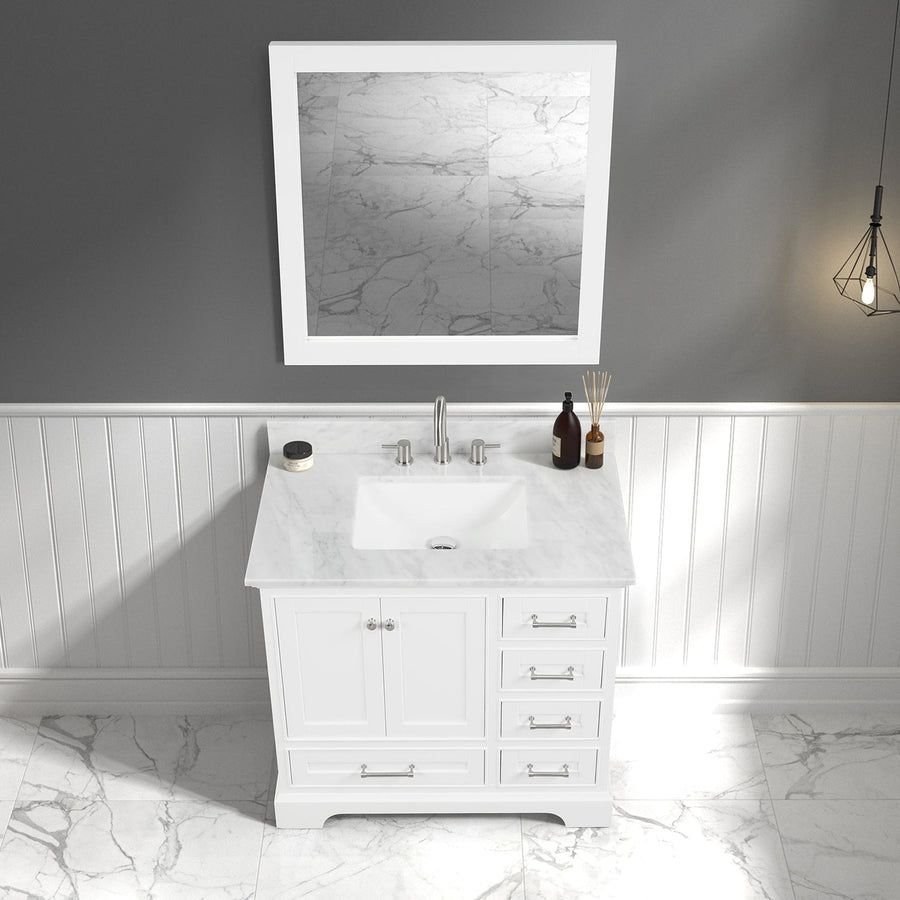 White bathroom vanity with marble top and gray walls