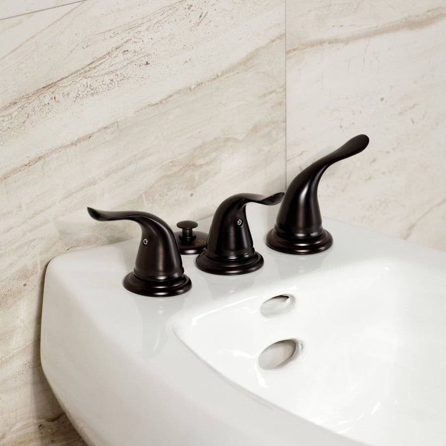 White bidet with dark bronze three-handle faucet