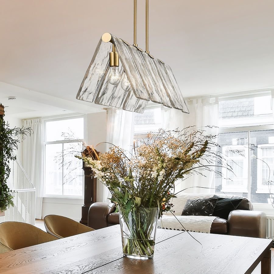 Living room idea with the Serenity Linear Pendant in Modern Brass with Hammered Water Glass Shad, Golden Lighting
