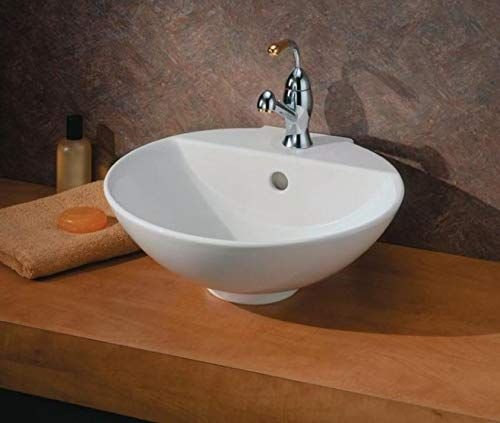 A round white vessel sink on a wood vanity top with a tall chrome faucet
