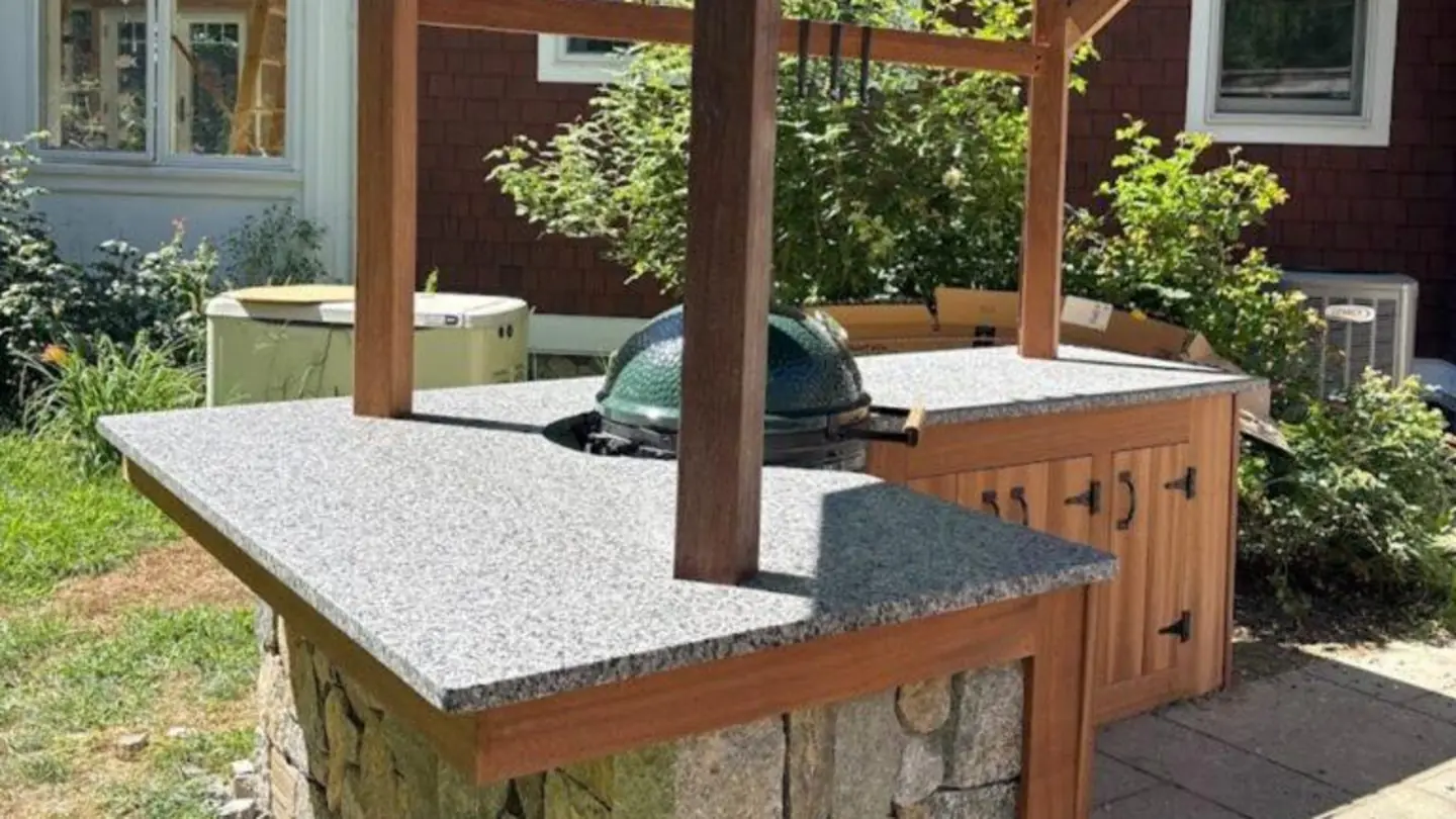 Outdoor kitchen with granite counter and stone base