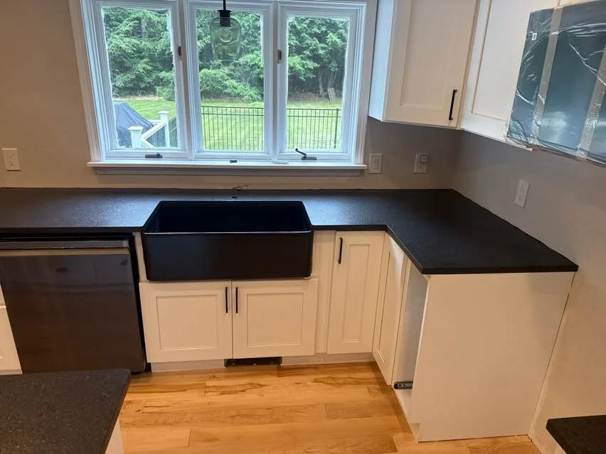 Leathered black granite kitchen with a farmhouse sink