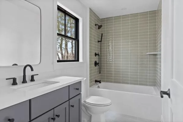 Walk-in tiled shower with a bench